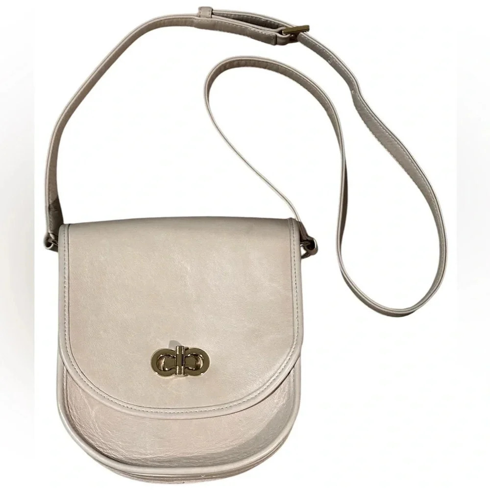 Lauren Merkin Stevie saddlebag style handbag, beige in color.